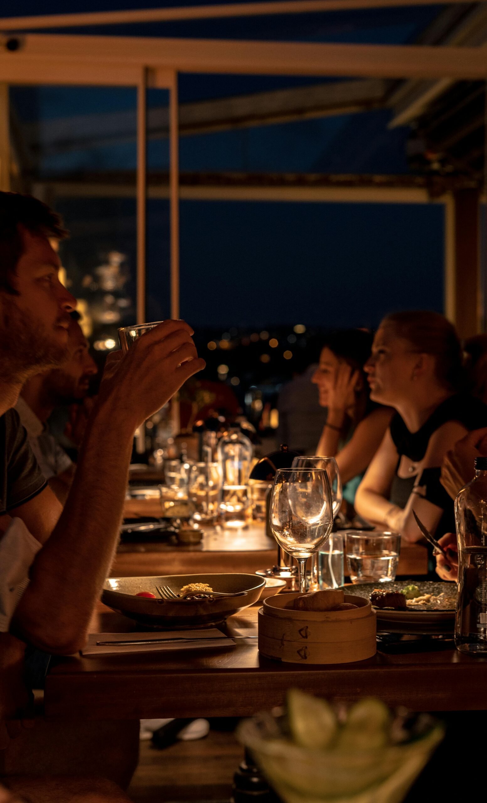 A cozy dinner scene at night in Istanbul, capturing candid interactions and ambient lighting.