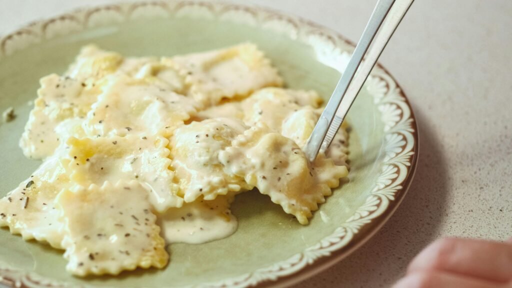 pexels-photo-31769307-31769307 Close-up of ravioli with creamy sauce on a plate in Ankara, Türkiye.